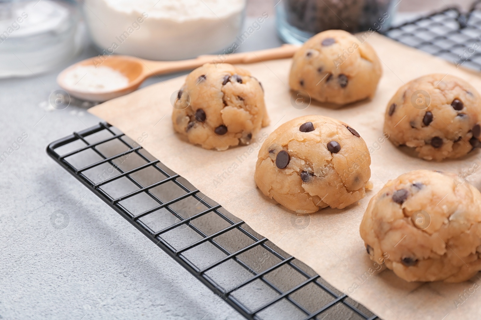 Photo of Cookie dough with chocolate chips on cooling rack, closeup