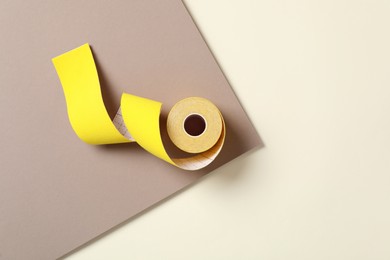 Photo of Bright kinesio tape in roll on color background, top view