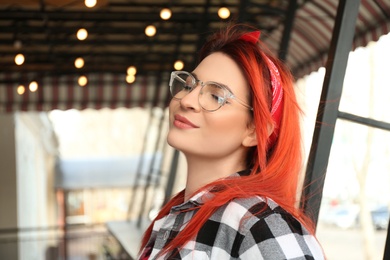 Young woman with bright dyed long hair outdoors