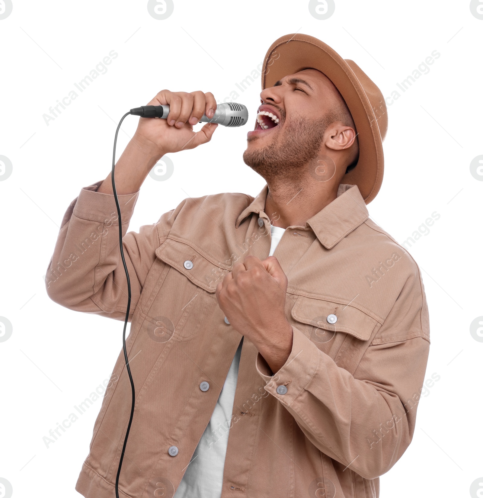 Photo of Handsome man with microphone singing on white background