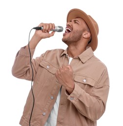 Handsome man with microphone singing on white background