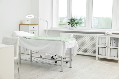 Modern interior of dermatologist's office with examination table