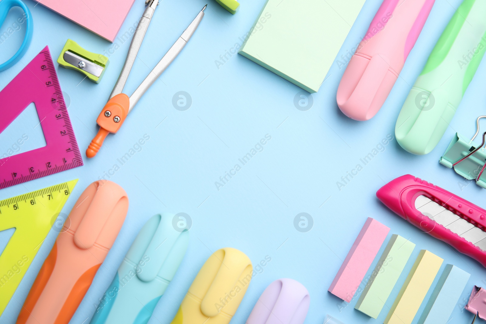 Photo of Frame of different school stationery on light blue background, flat lay. Back to school