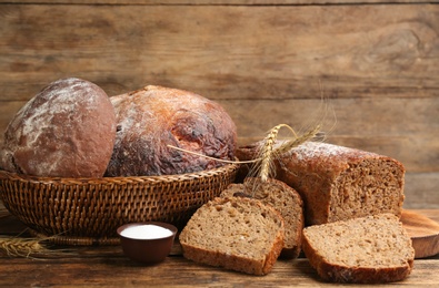 Photo of Tasty freshly baked bread on wooden table