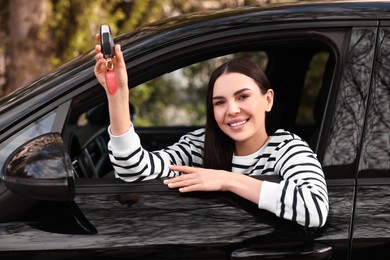 Photo of Woman holding car flip key inside her vehicle