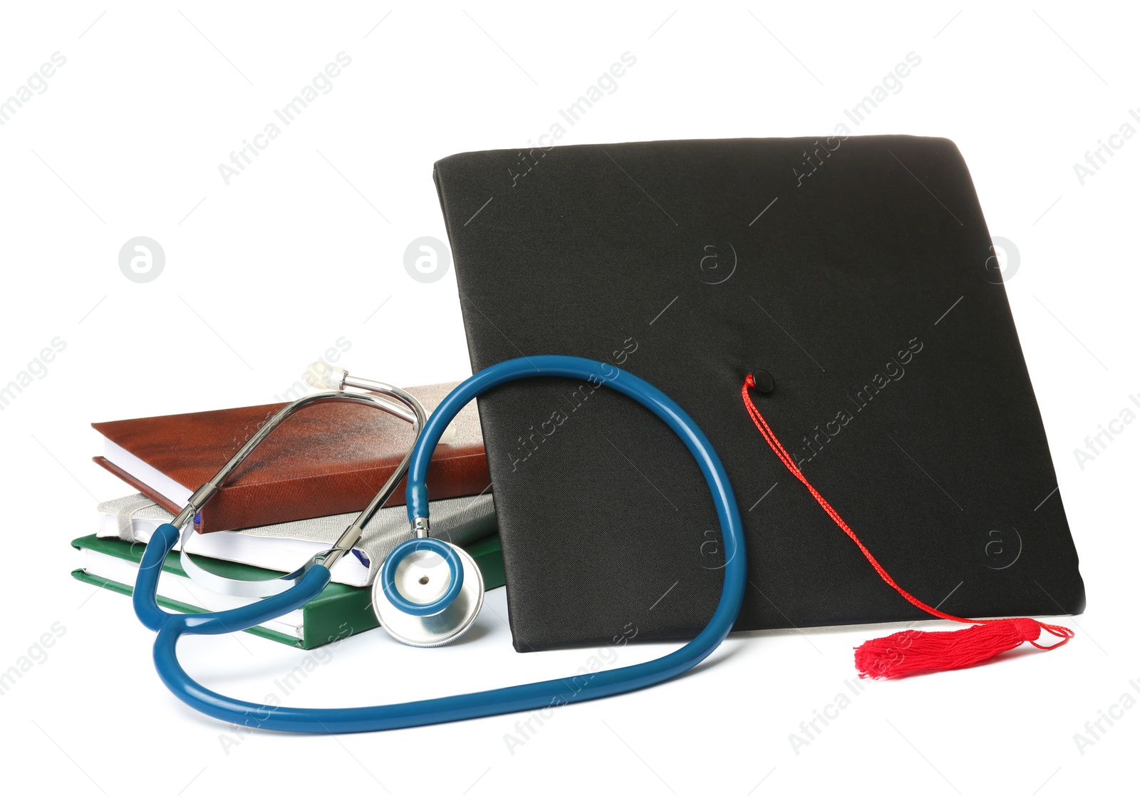 Photo of Stethoscope notebooks and graduation hat on white background. Medical students stuff