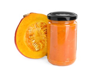 Jar of pumpkin jam and fresh pumpkin on white background