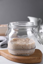 Photo of Sourdough starter in glass jar on light table