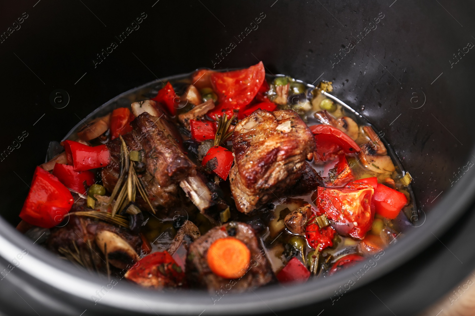 Photo of Closeup view of multi cooker with meat and vegetables