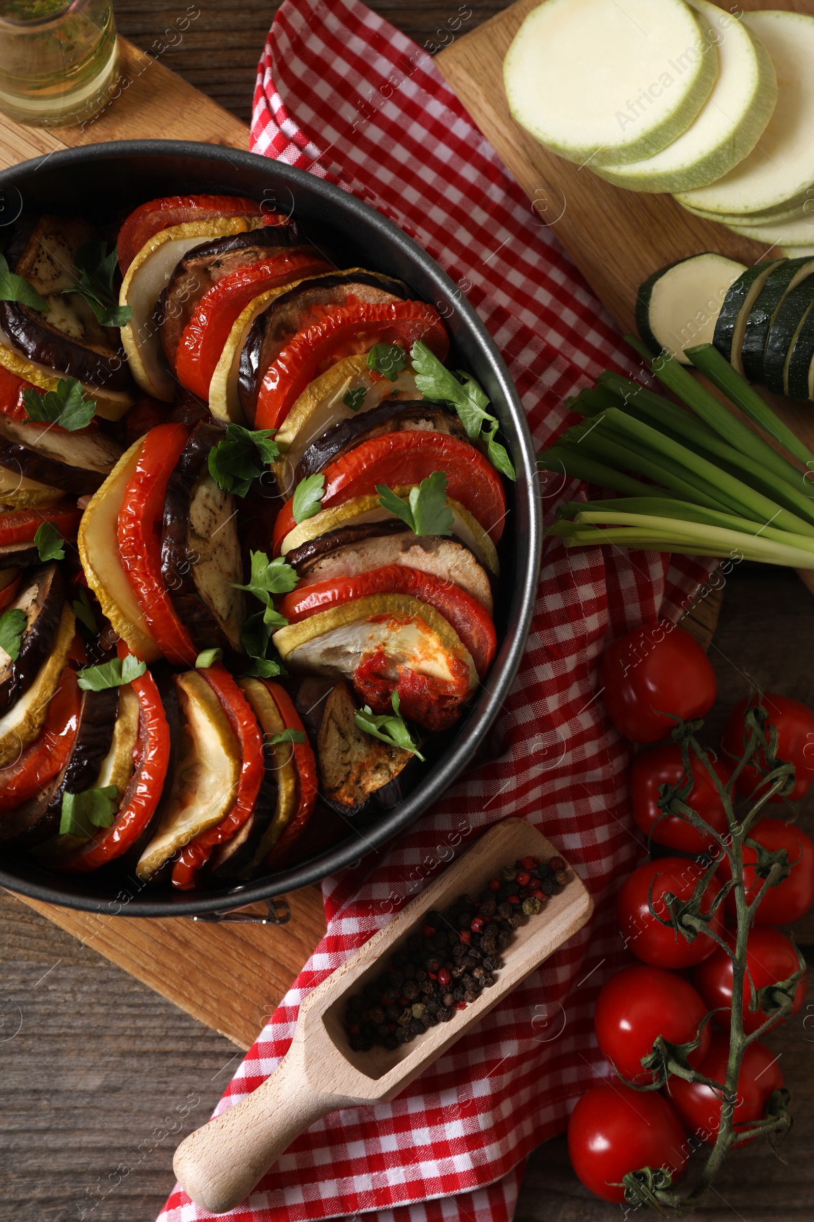 Photo of Delicious ratatouille and ingredients on table, flat lay