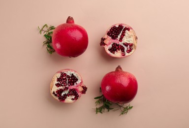 Flat lay composition with ripe pomegranates on beige background