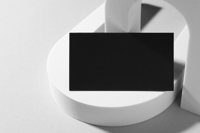 Photo of Empty black business card and decorative elements on white background. Mockup for design