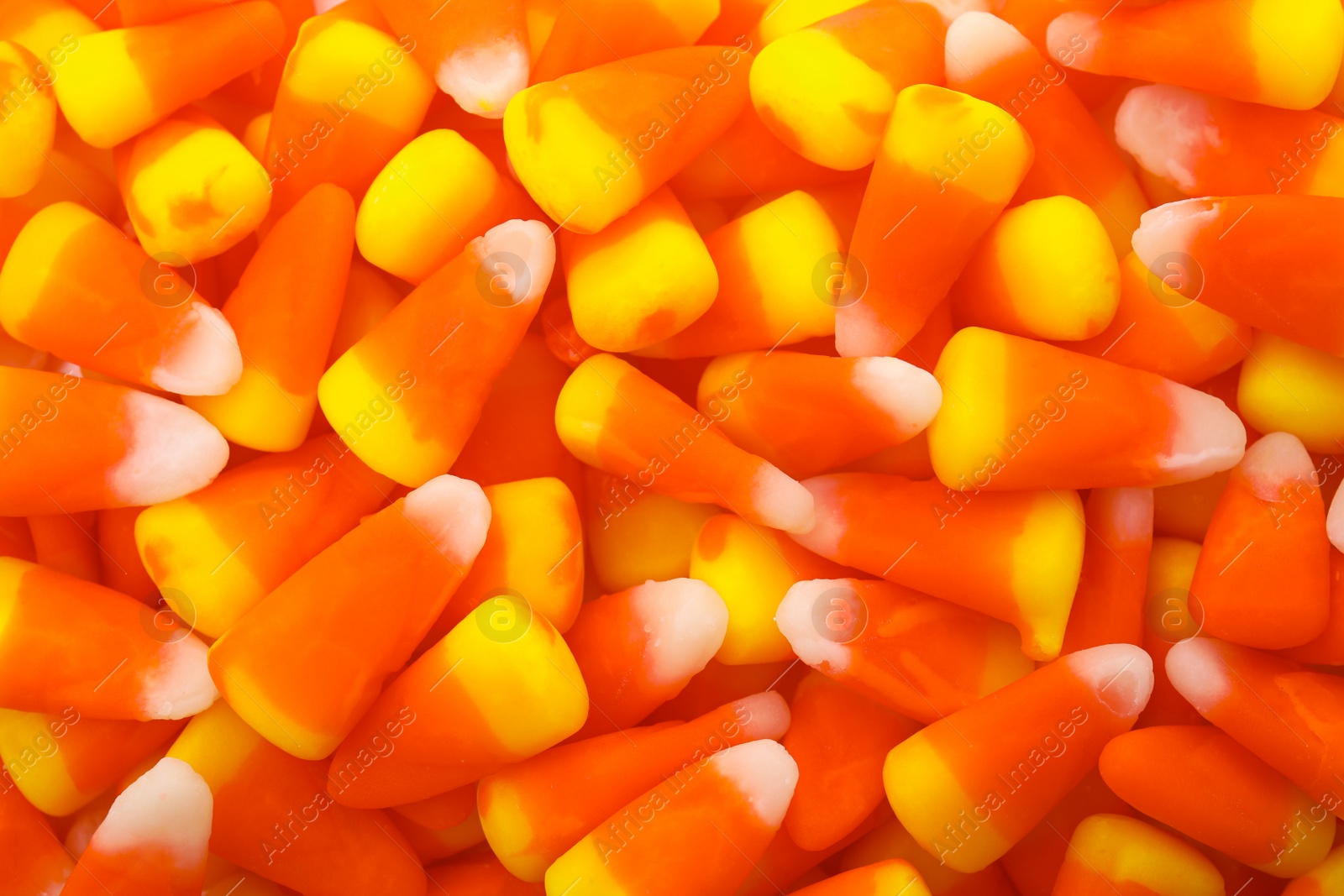 Photo of Delicious colorful candies as background, top view. Halloween sweets