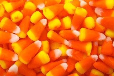 Delicious colorful candies as background, top view. Halloween sweets