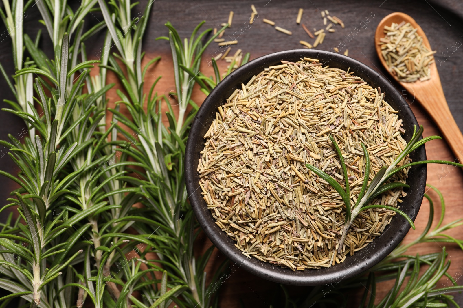 Photo of Dry and fresh rosemary on tray, flat lay