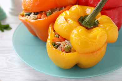 Photo of Tasty stuffed bell peppers on white wooden table, closeup