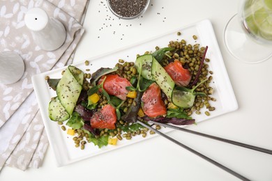 Photo of Plate of salad with mung beans on white table, flat lay