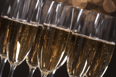 Photo of Many glasses of champagne on blurred background, closeup