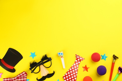 Photo of Flat lay composition with clown accessories on yellow background. Space for text