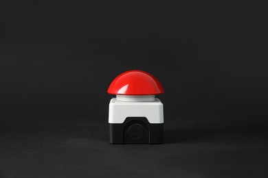 Photo of Red button of nuclear weapon on black background. War concept