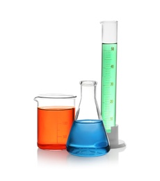 Photo of Laboratory glassware with colorful liquids on white background