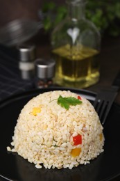 Photo of Delicious bulgur with vegetables and parsley served on table, closeup