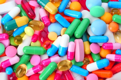 Photo of Assorted pills as background, top view. Medical treatment
