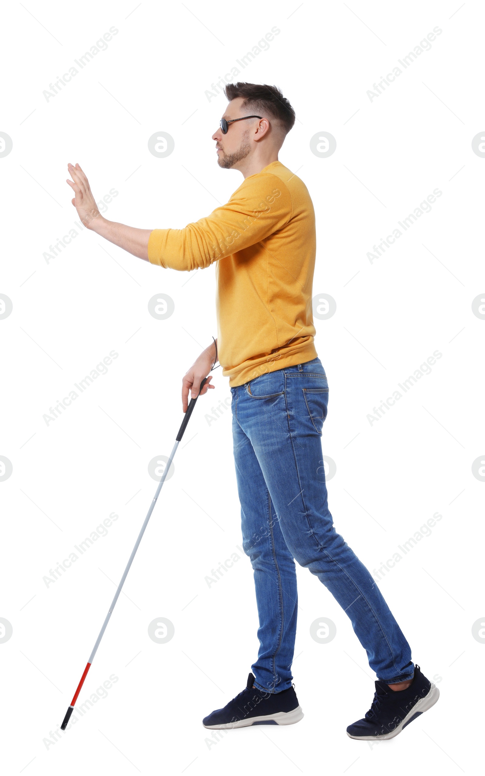 Photo of Blind man in dark glasses with walking cane on white background