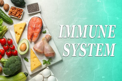 Immune system boosting with proper nutrition. Different foods on color table, flat lay