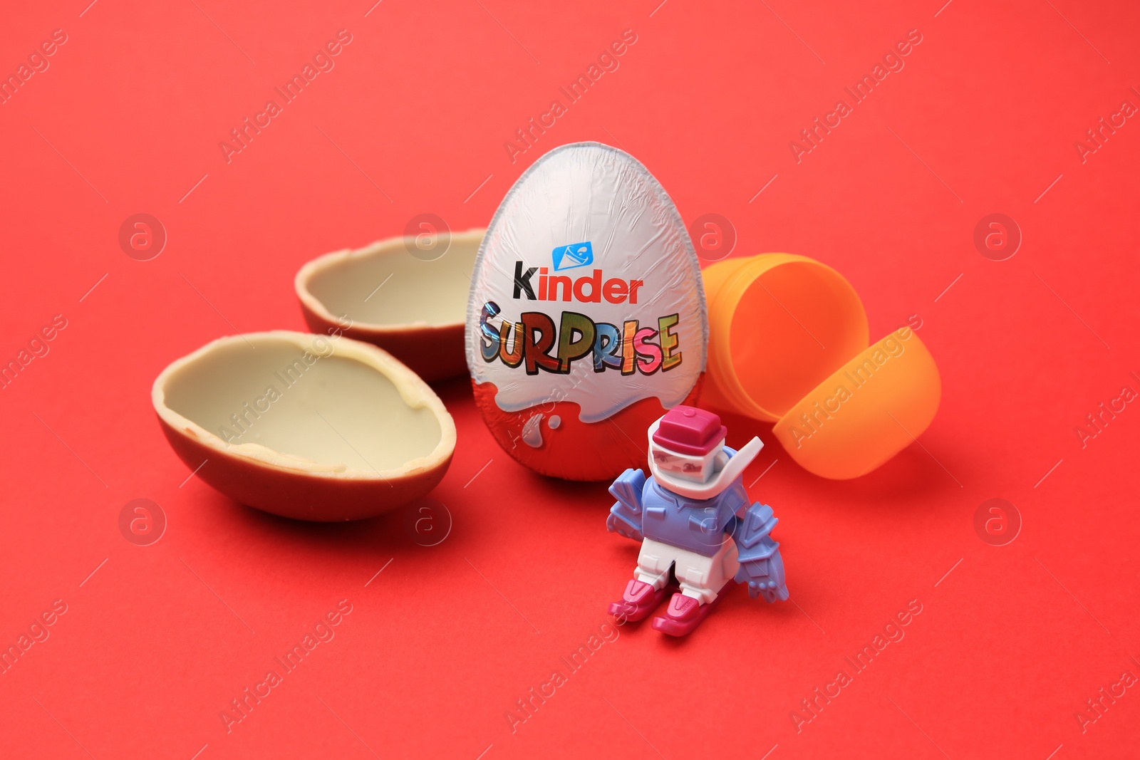 Photo of Sveti Vlas, Bulgaria - June 29, 2023: Kinder Surprise Eggs, plastic capsule and toy on red background