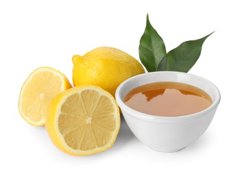 Photo of Ripe lemons, leaves and bowl of honey isolated on white