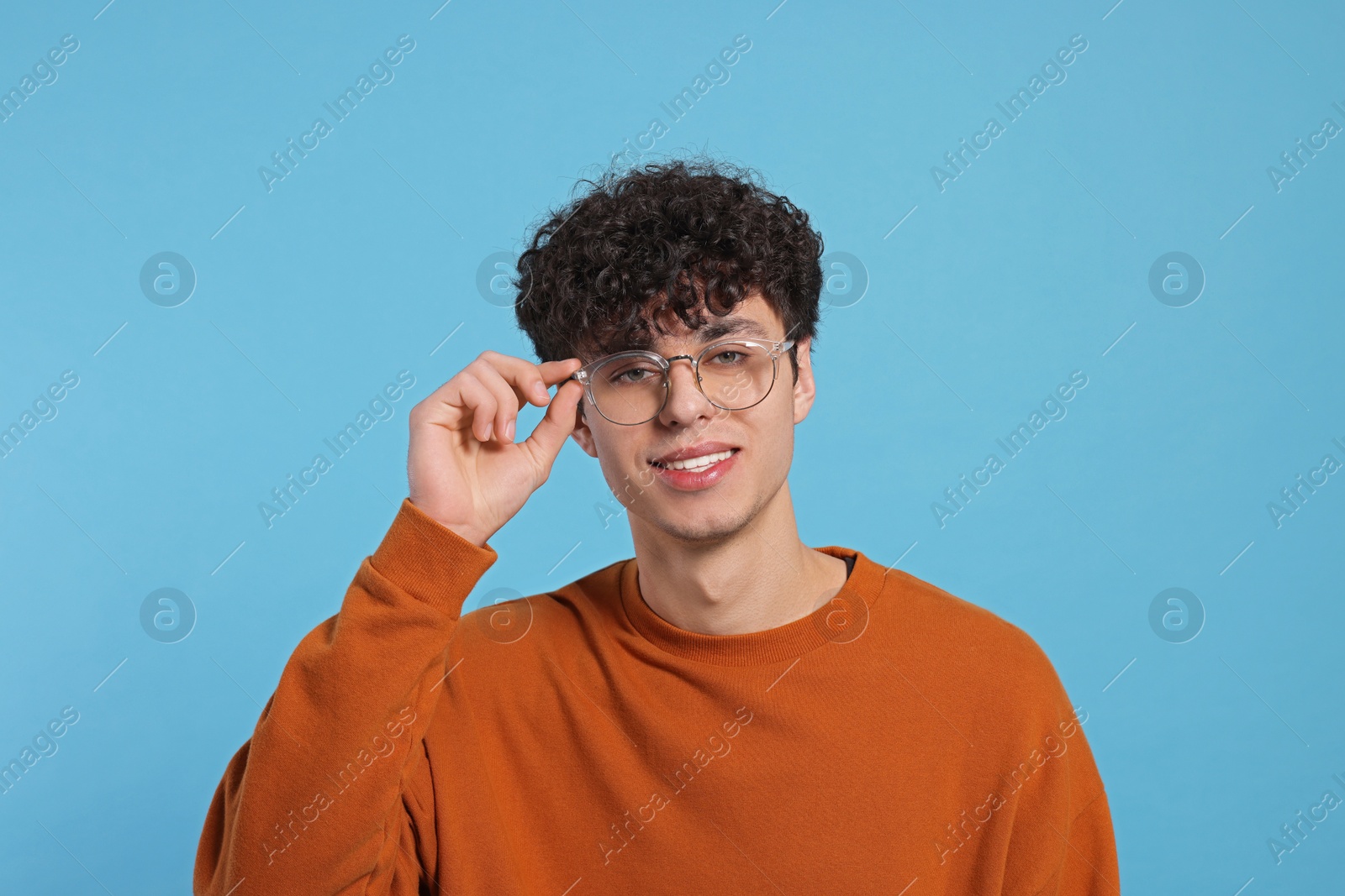 Photo of Portrait of handsome young man on light blue background