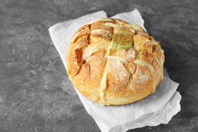 Photo of Freshly baked bread with tofu cheese on grey table