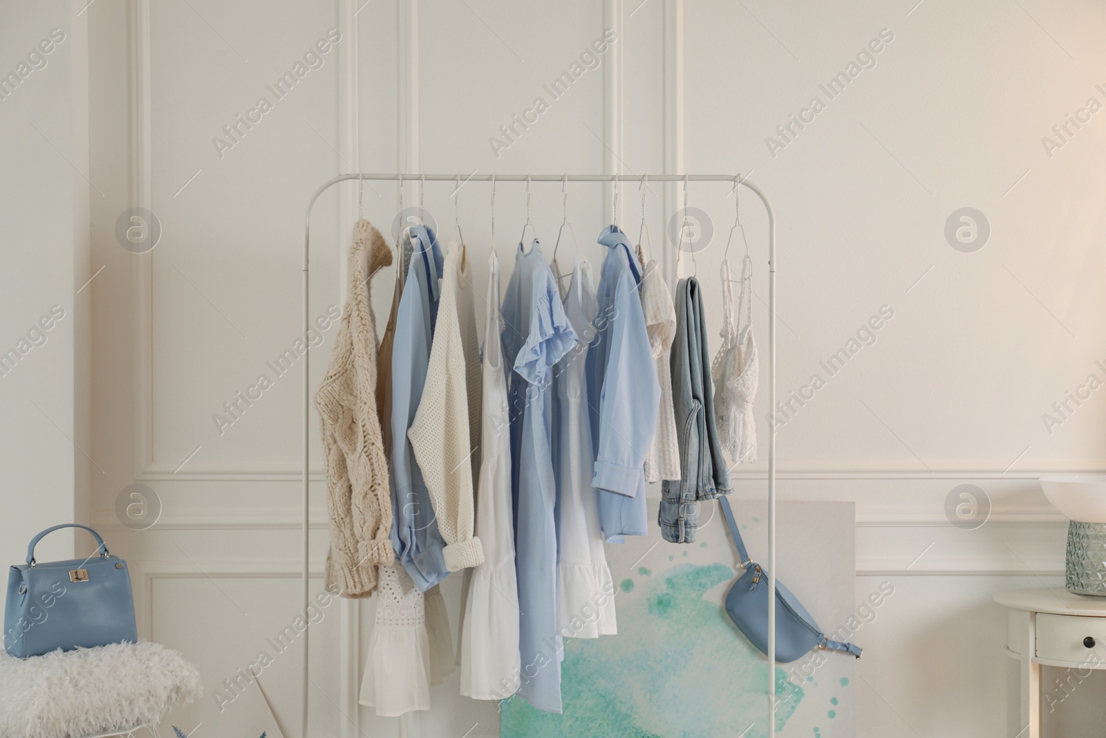 Photo of Rack with stylish clothes in modern dressing room