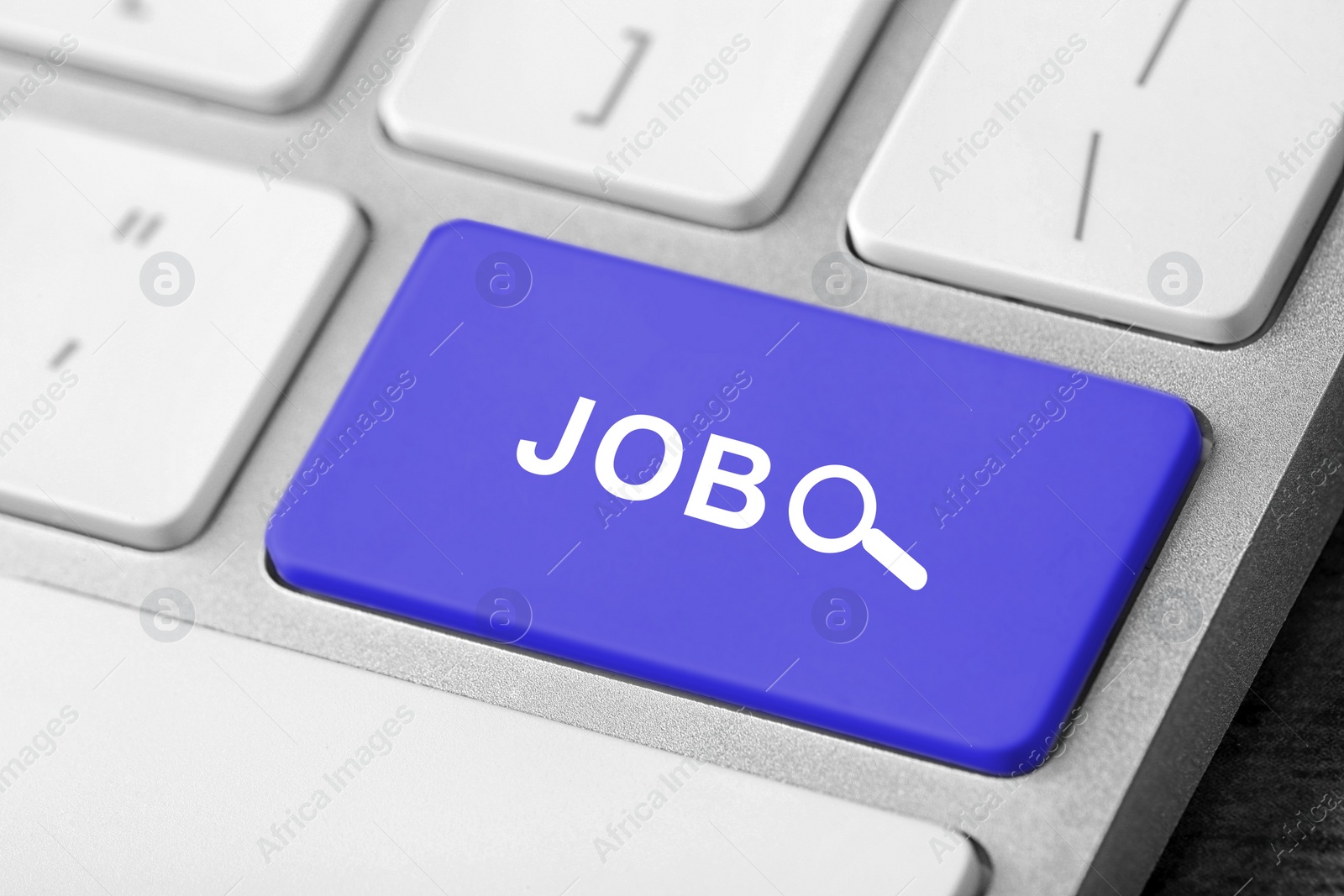 Image of Modern computer keyboard with blue button, closeup view. Job search