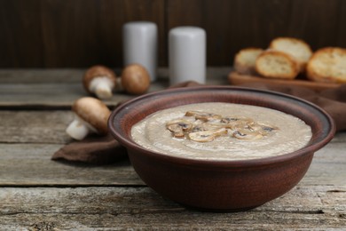 Delicious mushroom cream soup on wooden table. Space for text