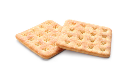 Photo of Crispy crackers isolated on white. Delicious snack