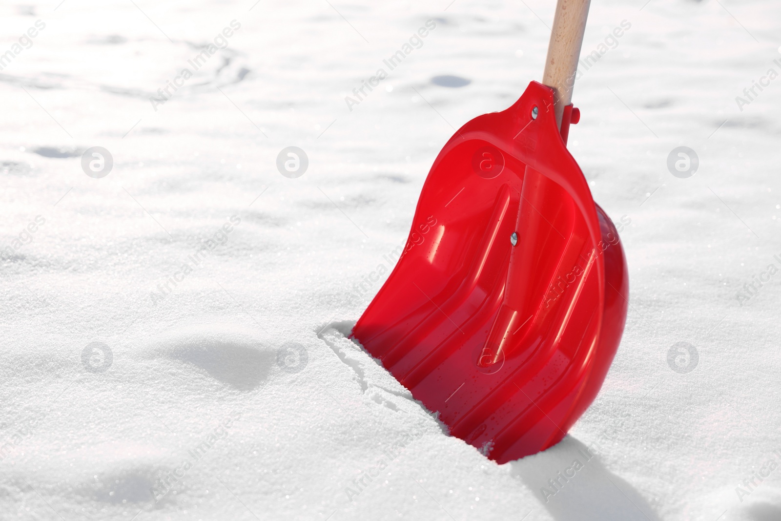 Photo of Snow shovel with wooden handle outdoors, closeup. Space for text