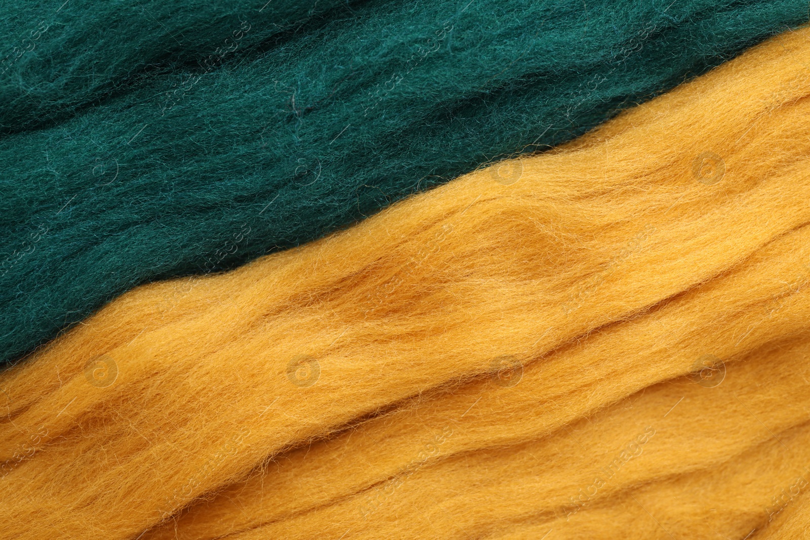 Photo of Colorful felting wool as background, closeup view