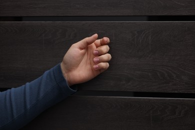 Photo of Collection agent knocking on wooden door, closeup