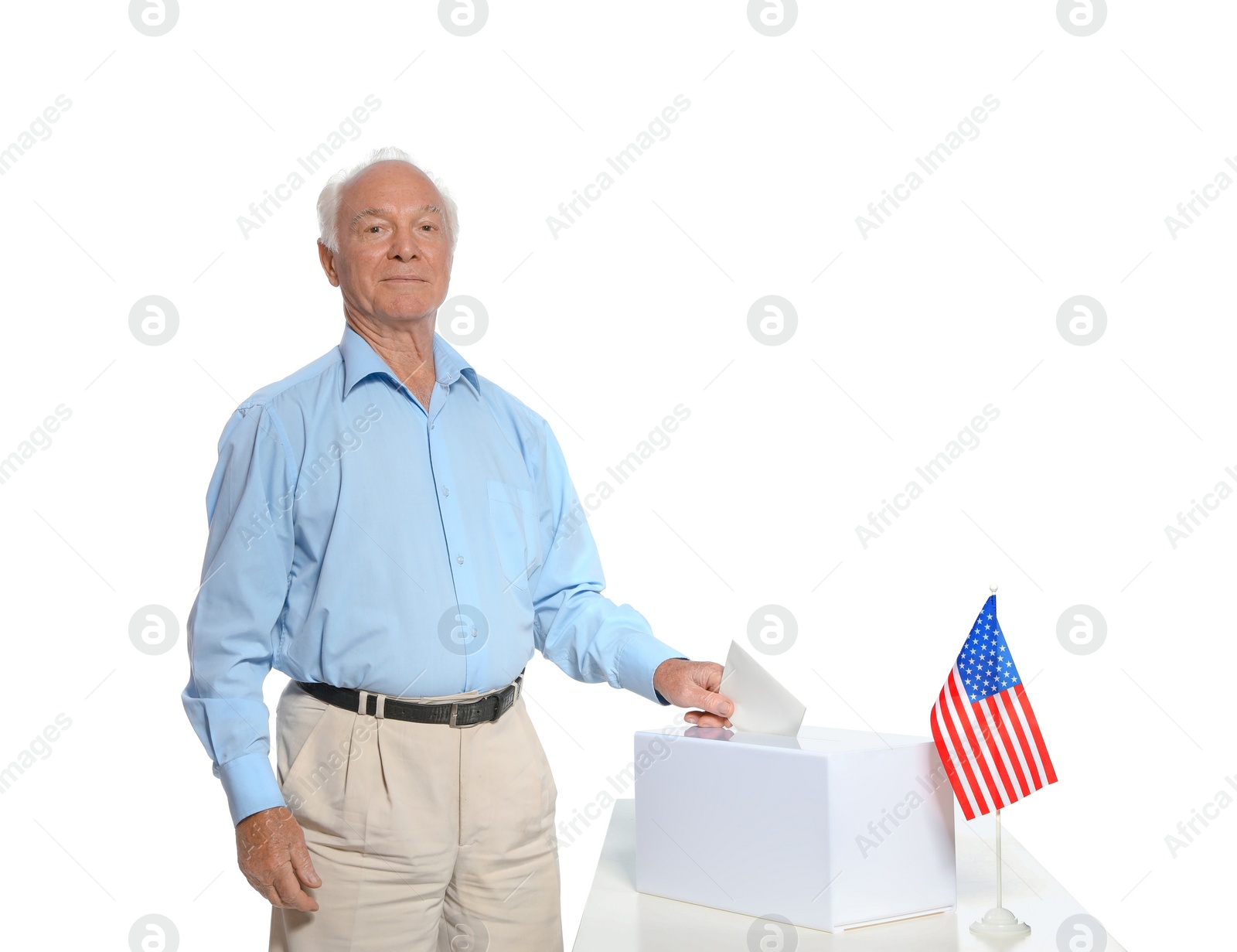 Photo of Elderly man putting ballot paper into box against white background