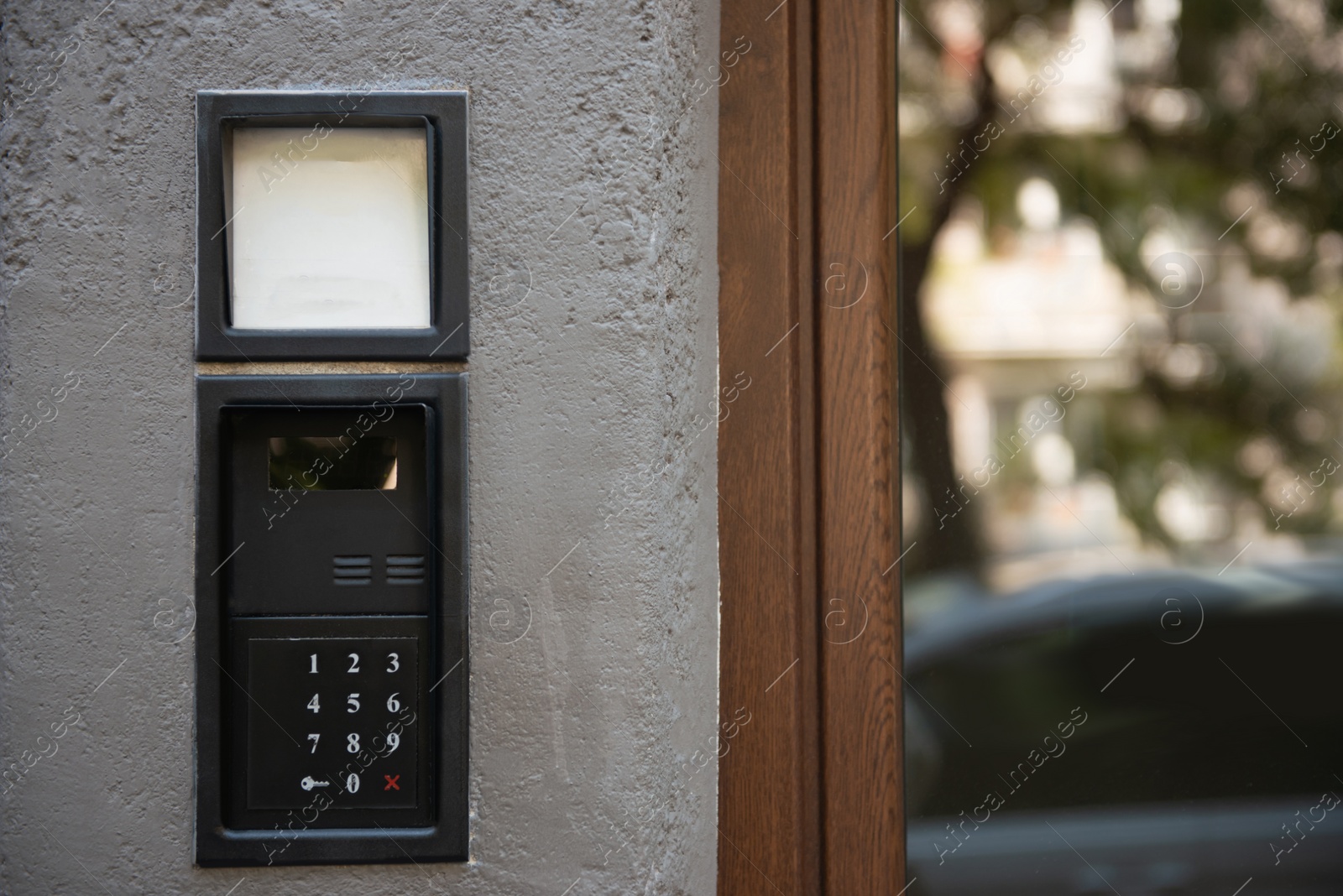 Photo of Home security system on light grey wall outdoors. Space for text