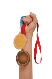 Photo of Woman holding gold and bronze medals on white background, closeup