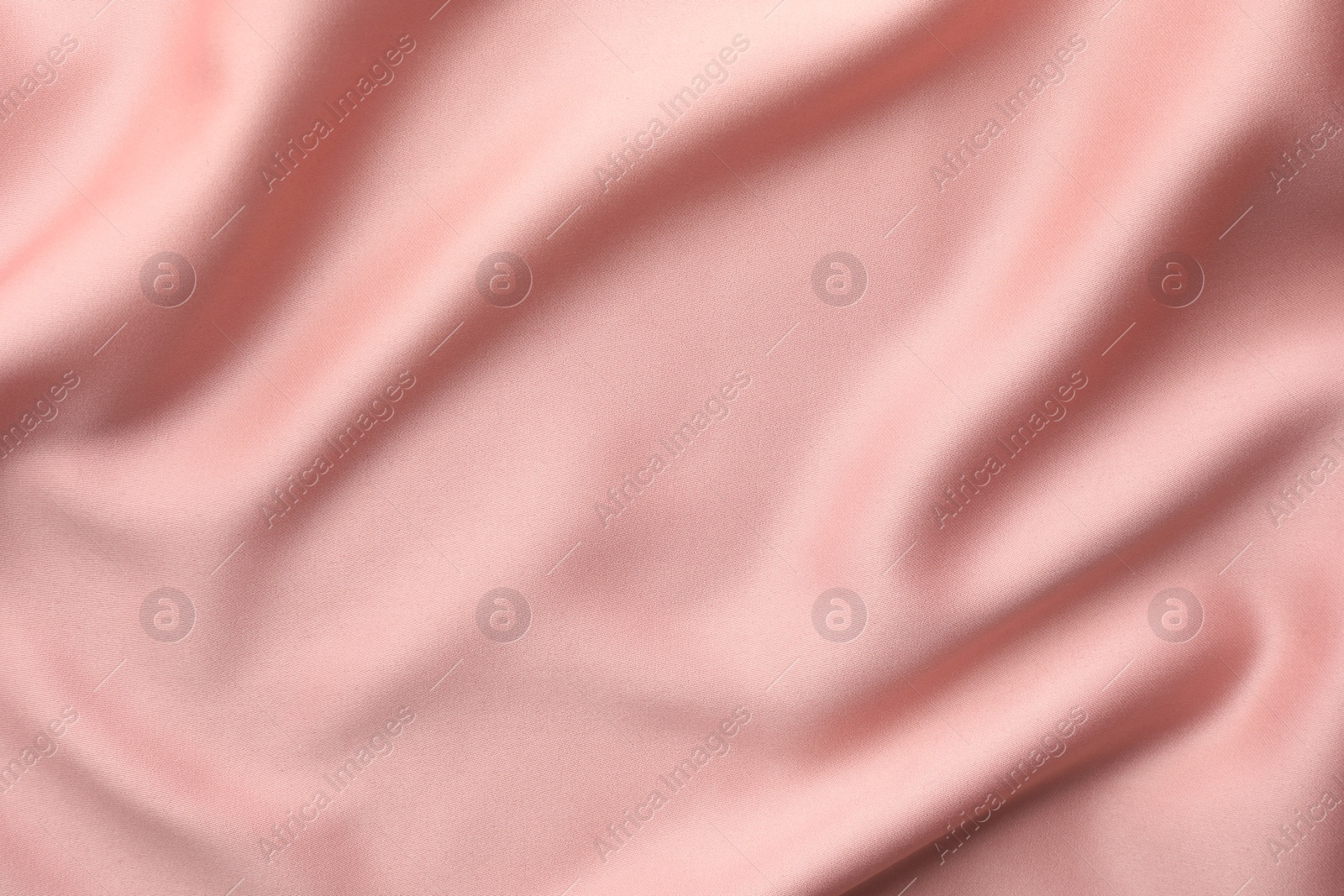 Photo of Crumpled pink silk fabric as background, top view