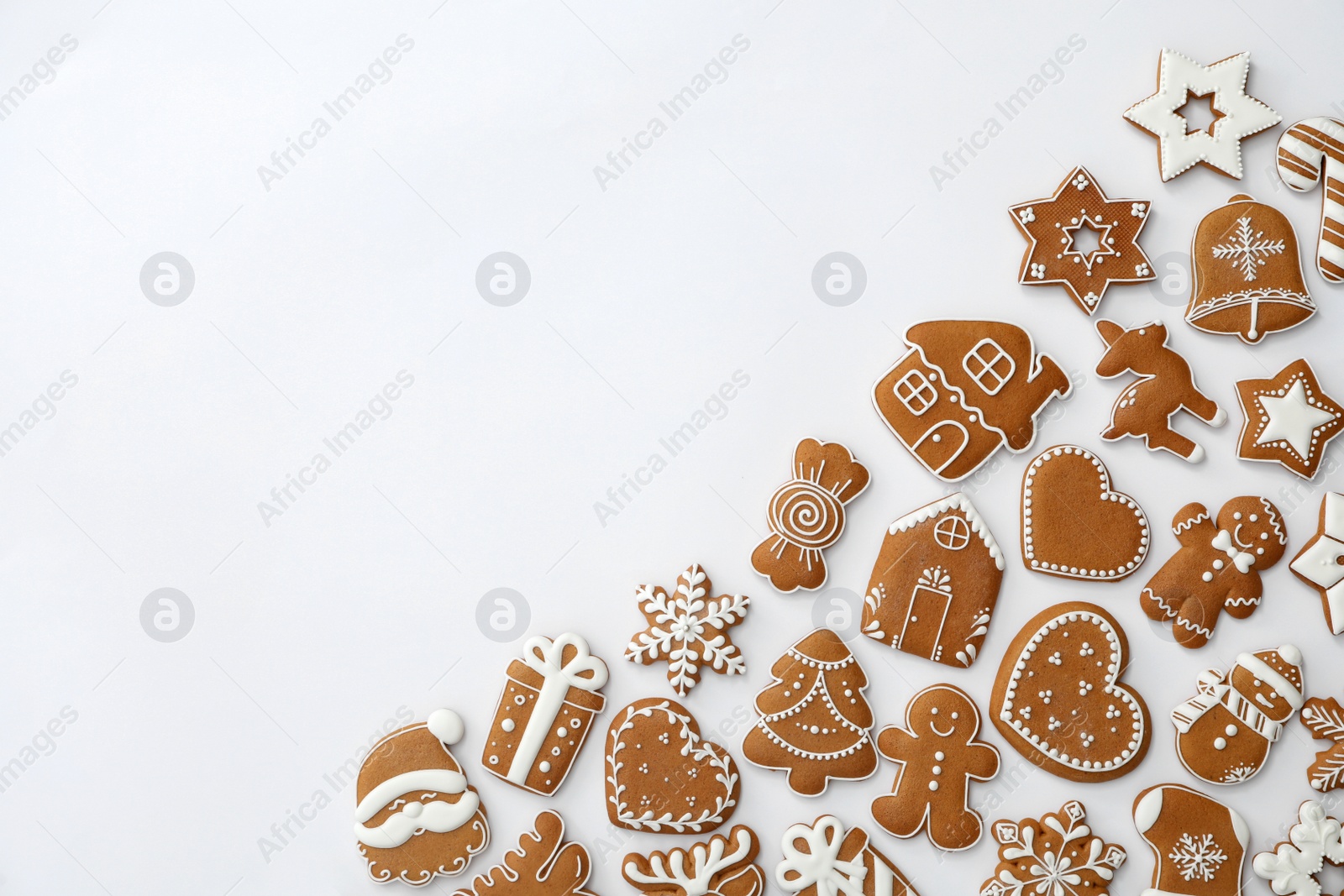 Photo of Different Christmas gingerbread cookies on white background, top view