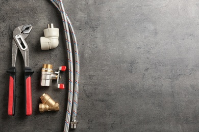 Photo of Flat lay composition with plumber's tools and space for text on gray background