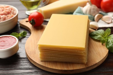 Photo of Ingredients for lasagna on wooden table, closeup