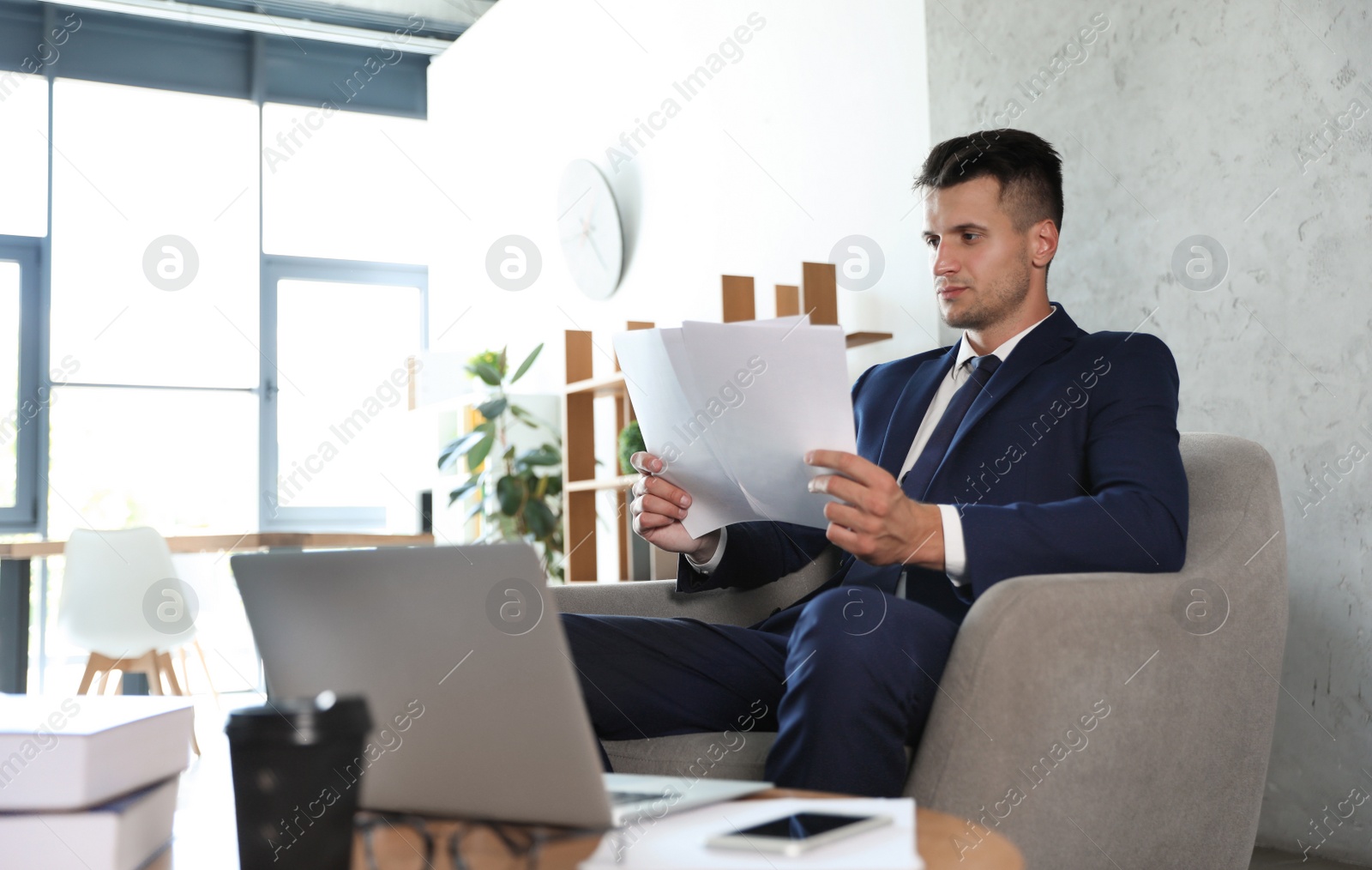 Photo of Male business trainer working with documents in office