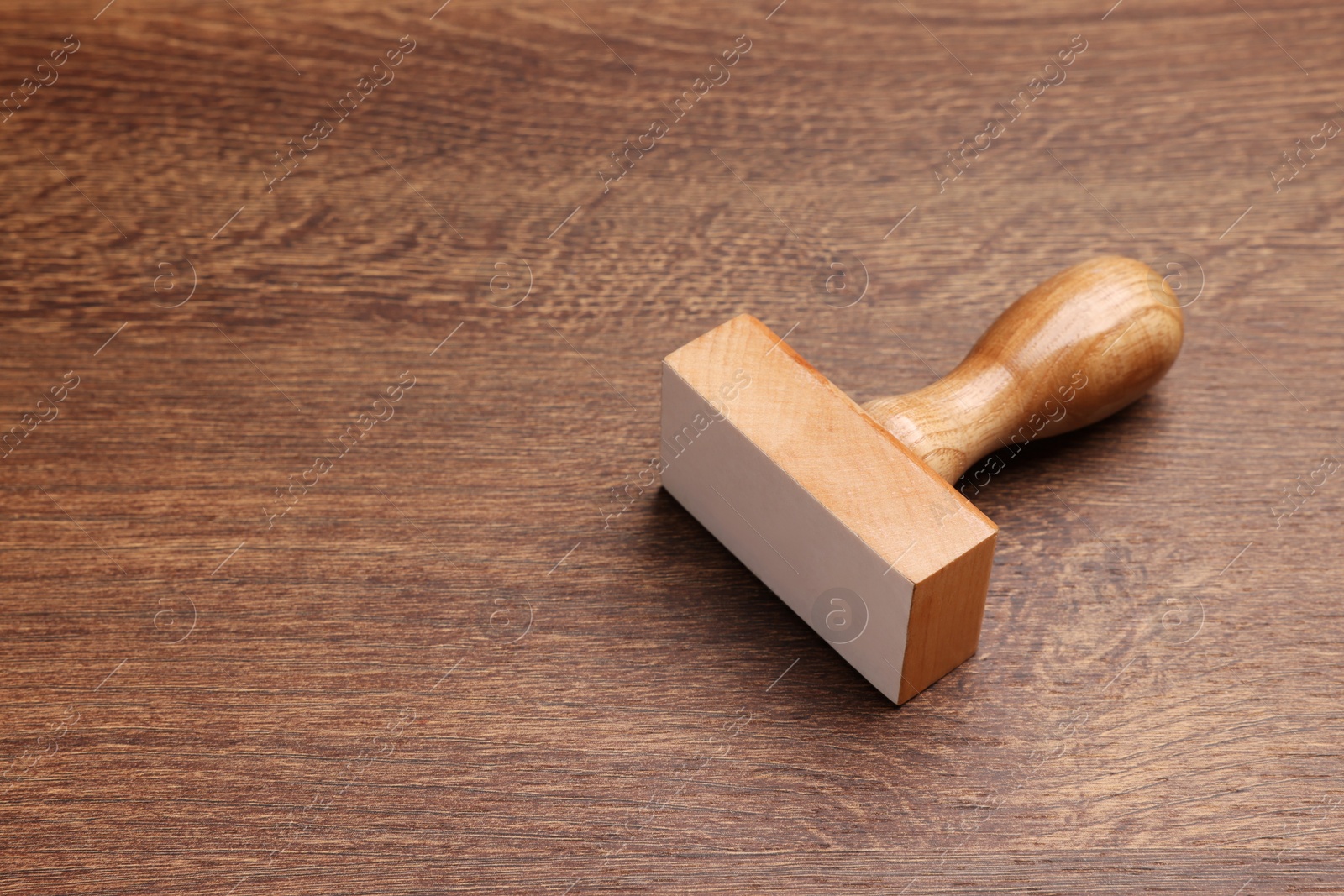 Photo of One stamp tool on wooden table, space for text