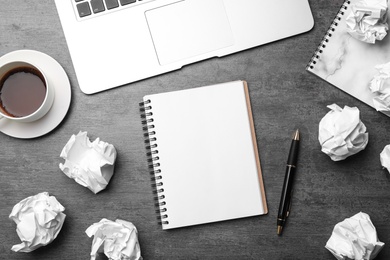 Photo of Flat lay composition with notebook and crumpled paper on grey table. Space for text